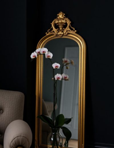 Gold framed mirror and orchid